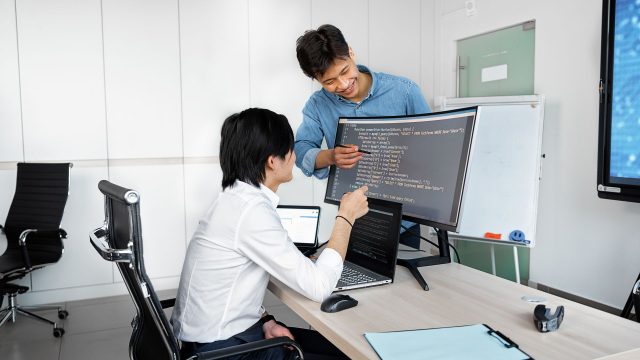 Engineers reviewing code on a monitor: Checks Product Teams Need to Run Before Wiring Up a Public-Record API