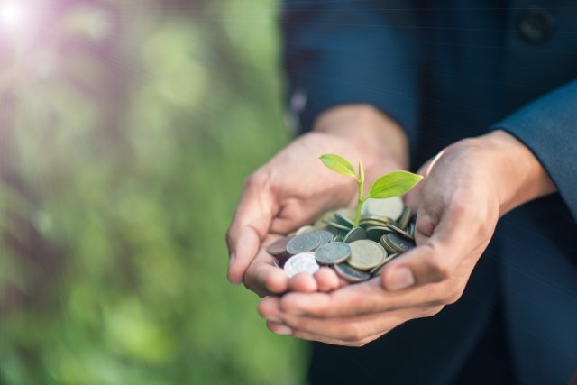 Business man with coins in hand
