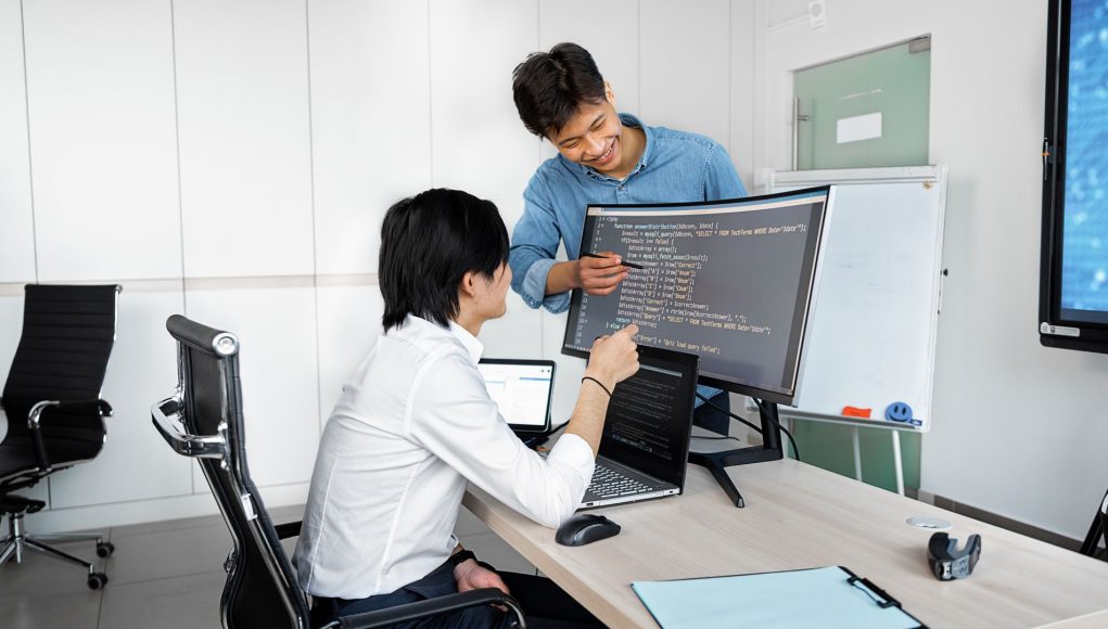 Engineers reviewing code on a monitor: Checks Product Teams Need to Run Before Wiring Up a Public-Record API