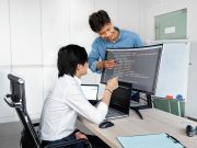 Checks Product Teams Need to Run Before Wiring Up a Public-Record API Engineers reviewing code on a monitor: Checks Product Teams Need to Run Before Wiring Up a Public-Record API