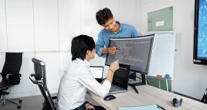 Engineers reviewing code on a monitor: Checks Product Teams Need to Run Before Wiring Up a Public-Record API