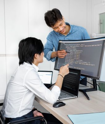 Engineers reviewing code on a monitor: Checks Product Teams Need to Run Before Wiring Up a Public-Record API