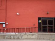 Security camera and rear entrance on a commercial building: Crime Forecast to Hit Nearly One UK Business in Three This Year