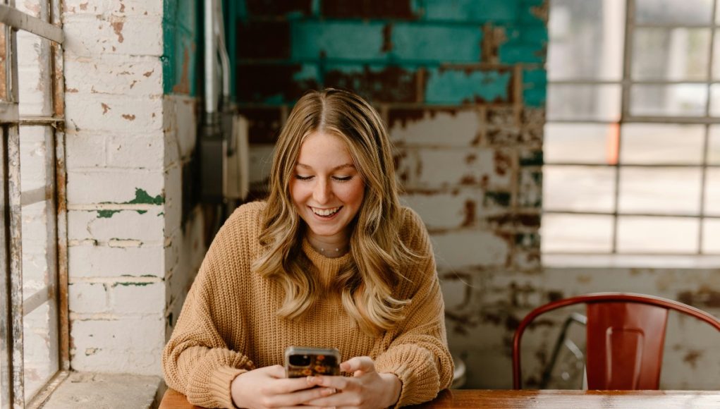 Borrower checking a loan account on a smartphone: Good Lenders Stay Available Throughout the Repayment Journey