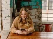 Borrower checking a loan account on a smartphone: Good Lenders Stay Available Throughout the Repayment Journey