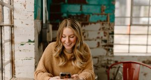 Borrower checking a loan account on a smartphone: Good Lenders Stay Available Throughout the Repayment Journey