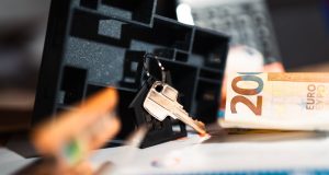 Keys with a house model, Euro bills, and charts suggesting real estate and financial themes.