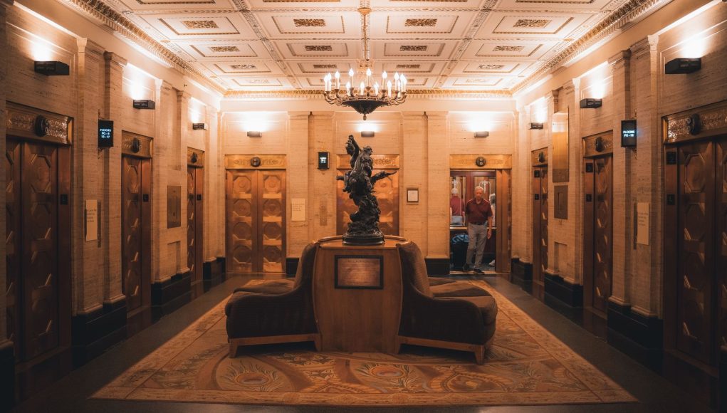 A lift lobby in an older building, where ageing lifts face a repair, modernise or replace decision