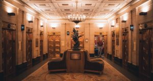 A lift lobby in an older building, where ageing lifts face a repair, modernise or replace decision