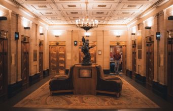 A lift lobby in an older building, where ageing lifts face a repair, modernise or replace decision