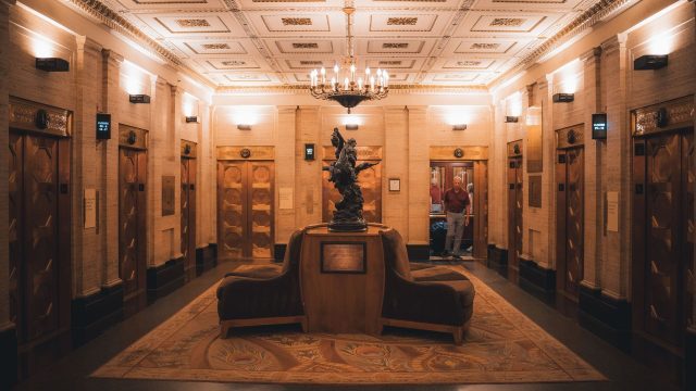 A lift lobby in an older building, where ageing lifts face a repair, modernise or replace decision
