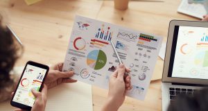Great PPC and SEO Partners Are Built on Industry-Specific Experience: marketing specialists reviewing SEO and campaign analytics charts at a desk