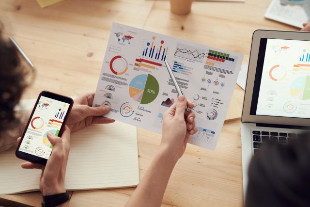 Great PPC and SEO Partners Are Built on Industry-Specific Experience: marketing specialists reviewing SEO and campaign analytics charts at a desk